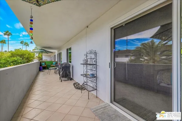 a view of balcony with furniture