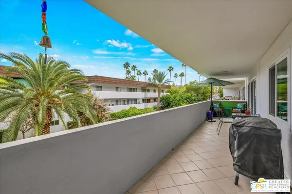 a view of a house with a palm tree