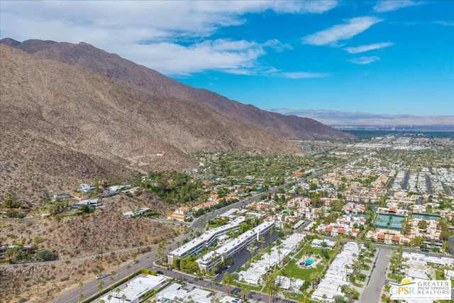 an aerial view of a house with a swimming pool and outdoor seating