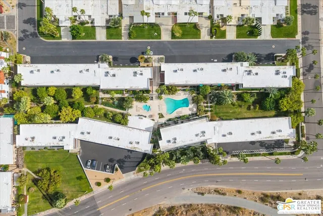 a view of a backyard with plants and outdoor seating