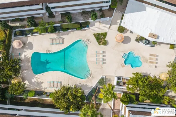 a swimming pool with outdoor seating and yard