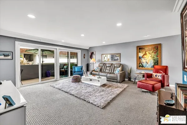 a living room with furniture rug and window