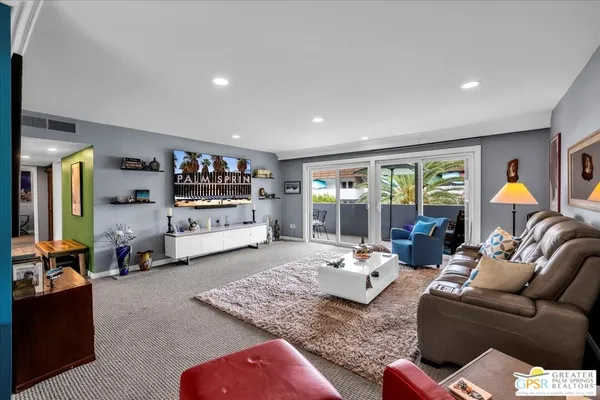 a living room with furniture rug and window