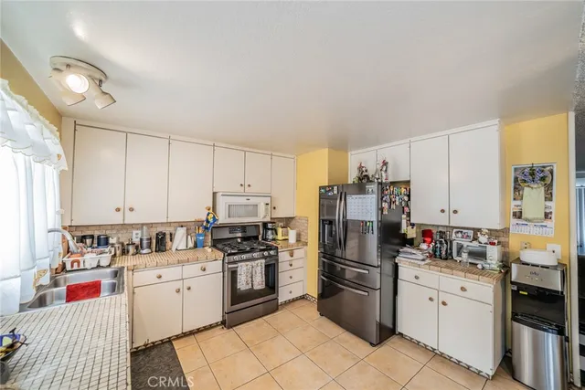 a kitchen with stainless steel appliances and white cabinets