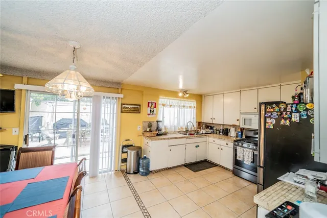 a kitchen with a sink stainless steel appliances and white cabinets