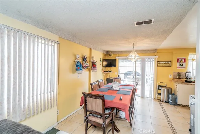 a dining room with furniture and a window