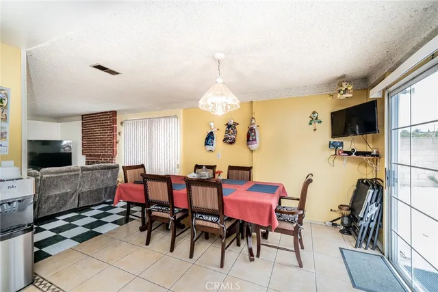 a view of a dining room with furniture and a kitchen