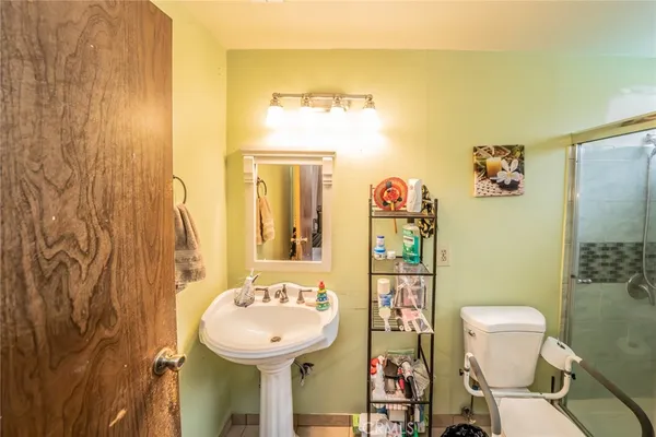 a bathroom with a toilet sink and mirror