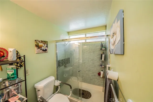 a bathroom with a shower and a toilet