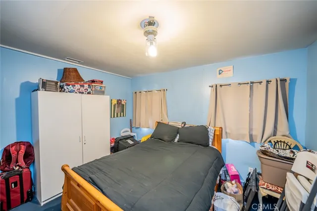 a bedroom with bed and a window