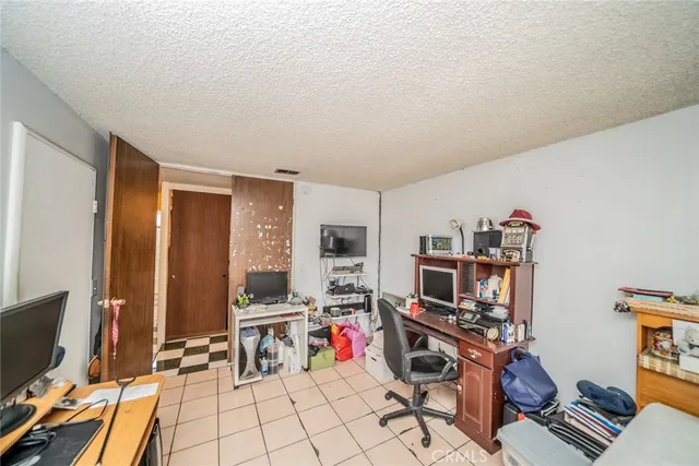 a view of a workspace with furniture and a flat screen tv