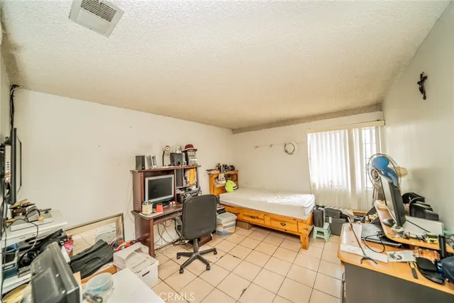 a bedroom with furniture and a gym equipment