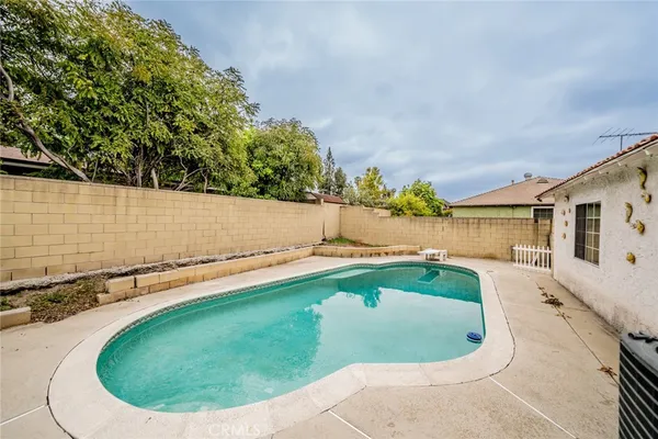 a view of a swimming pool with a yard