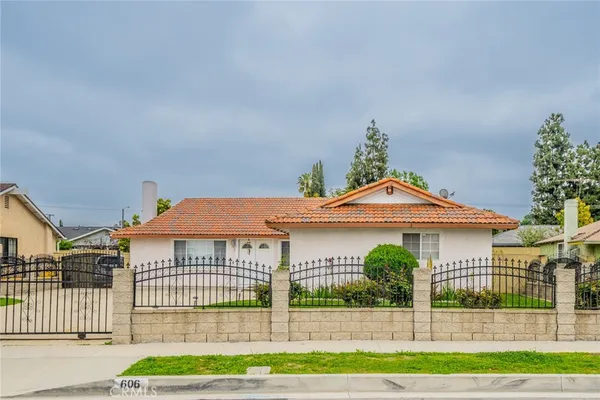 a front view of a house with a garden
