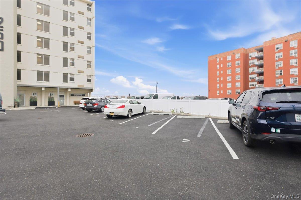 250 Shore Road, Unit 4D Long Beach, NY 11561 - Photo 13 of 16 a cars parked in front of a building