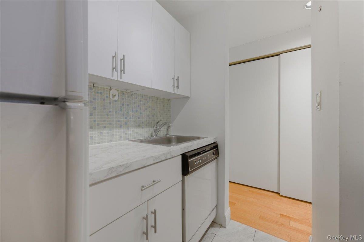 250 Shore Road, Unit 4D Long Beach, NY 11561 - Photo 5 of 16 a kitchen with a sink and cabinets