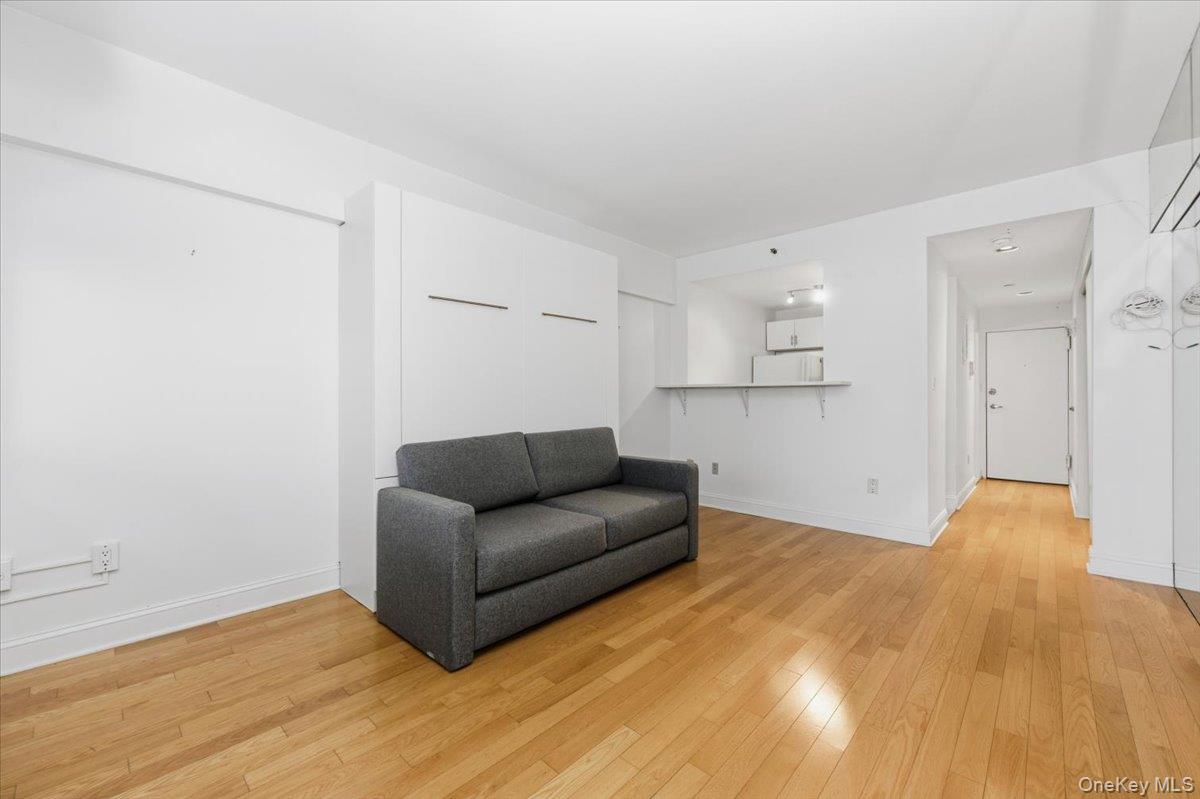 250 Shore Road, Unit 4D Long Beach, NY 11561 - Photo 8 of 16 a view of a livingroom with a couch and a wooden floor