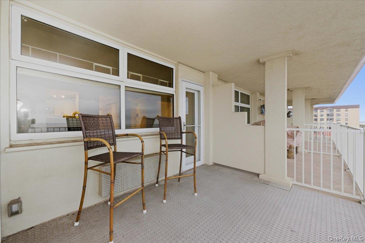 250 Shore Road, Unit 4D Long Beach, NY 11561 - Photo 10 of 16 a dining room with furniture and a kitchen view