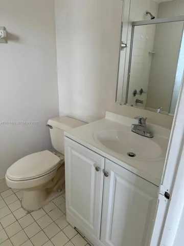 a bathroom with a sink toilet and mirror