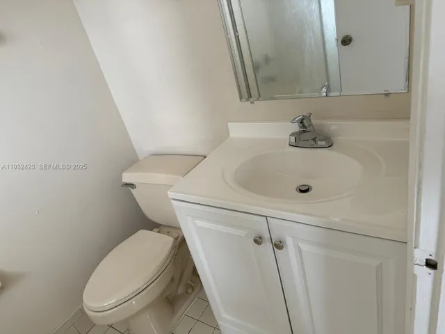 a white toilet sitting next to a bathroom sink