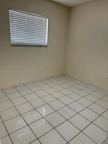 a view of a white wall and next to a window