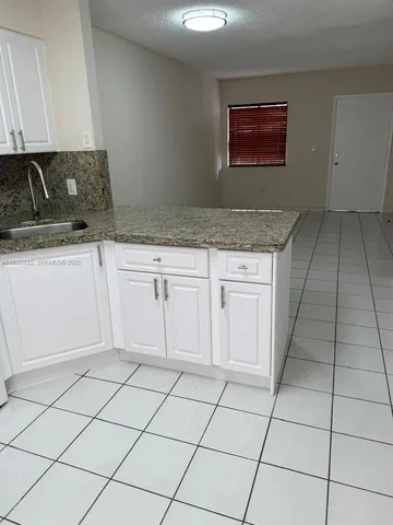 a kitchen with cabinets and appliances