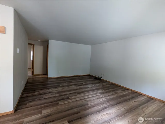 a view of a room with wooden floor