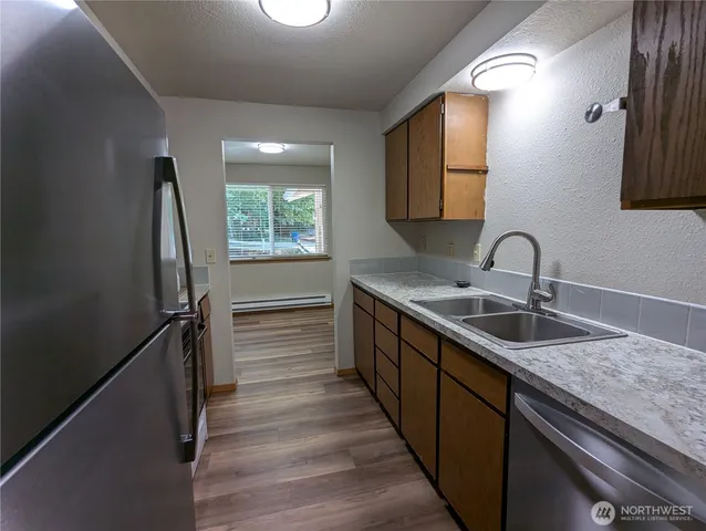 a kitchen with sink and mirror
