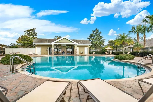 an aerial view of a house with a yard and a lake view