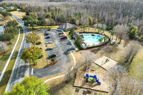 a view of a yard with trees in the background
