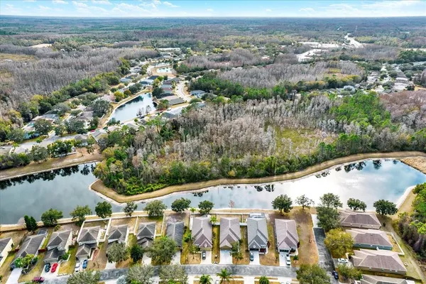 an aerial view of a house with a yard basket ball court and outdoor seating