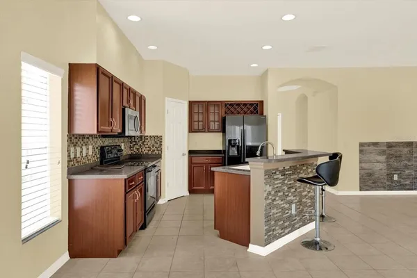 a view of kitchen with cabinets and stainless steel appliances