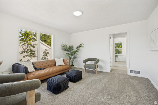 662 29th Street Ogden, UT 84403 - Photo 2 of 23 Bright living space featuring neutral-toned carpet, white walls, and a prominent window