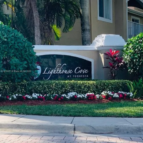 a front view of a house with yard and green space