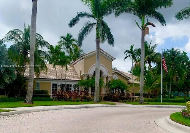 a view of a swimming pool with a lawn chair and palm trees
