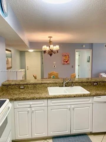 a kitchen with a sink and a refrigerator