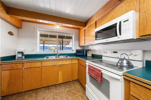 a kitchen with stainless steel appliances granite countertop a sink and cabinets