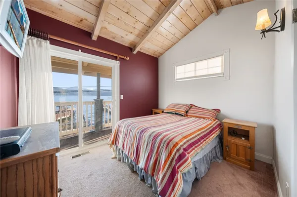 a bedroom with a bed next to a large window