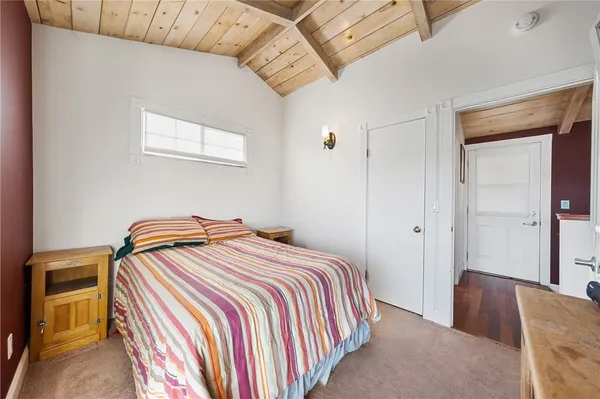 a bedroom with a bed and dresser