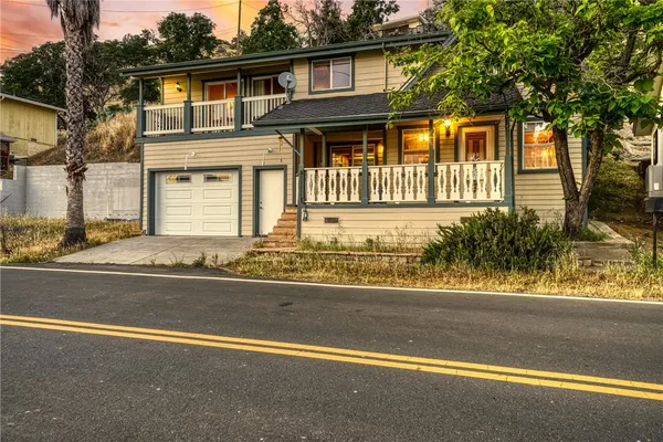a front view of a house with a yard and a garage