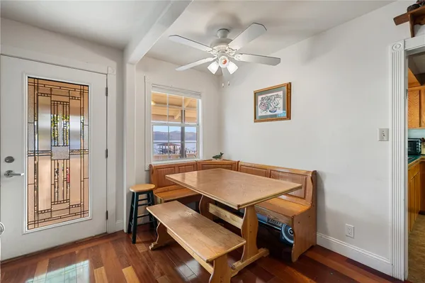 a dining room with wooden floor and a chandelier