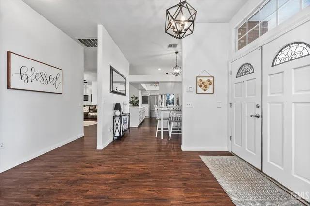 a view of a dining room with furniture wooden floor and chandelier