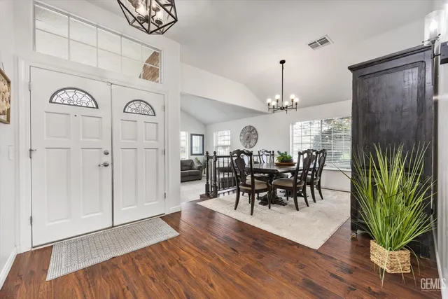 a view of a dining room with furniture and chandelier