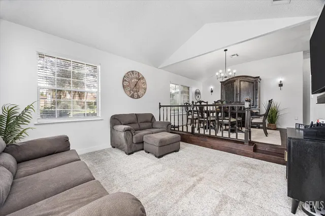 a living room with fireplace furniture and a flat screen tv