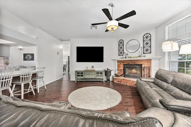 a living room with furniture flat screen tv and outdoor view