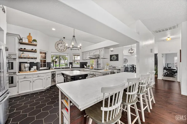 a kitchen with cabinets and stainless steel appliances