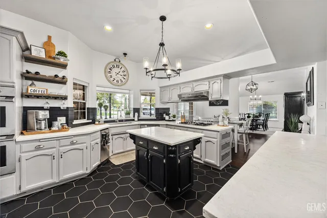 a kitchen with stainless steel appliances granite countertop a sink and cabinets