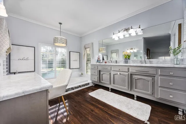 a spacious bedroom with a bed a couch and a chandelier