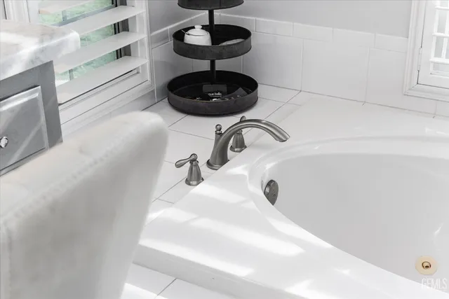 a bedroom with furniture and a flat screen tv