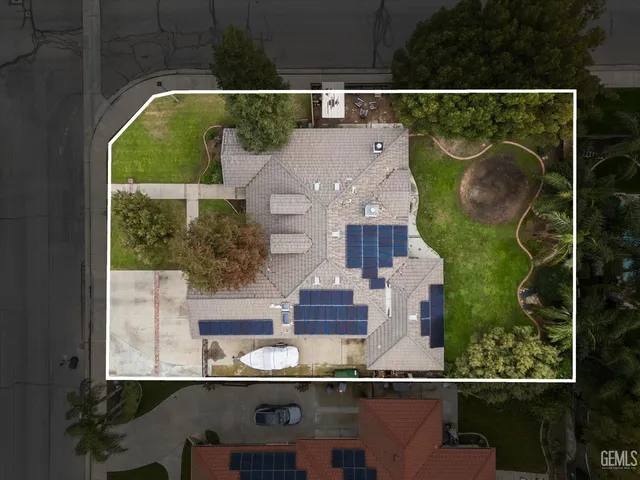 an aerial view of residential houses with outdoor space and pool